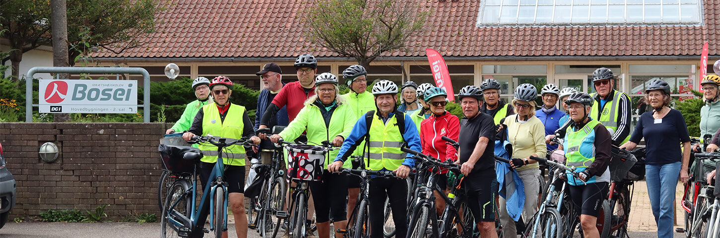 Kursister med cykler foran Idrætshøjskolen Bosei