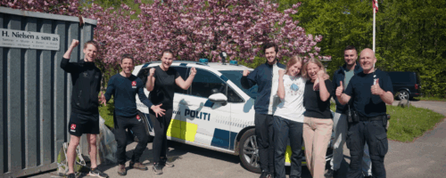 Elever og undervisere foran en politibil